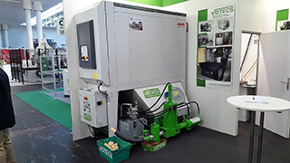 VOTECS booth with wood crusher and briquetting press